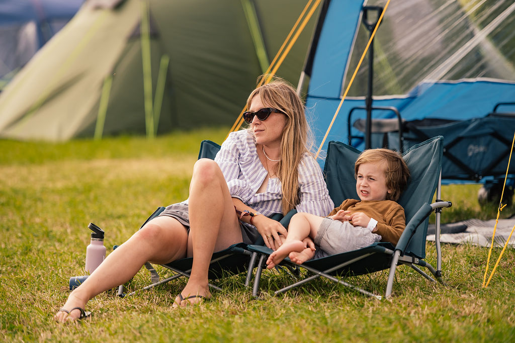 Camping Rock Oyster 2026 Mother and child sat outside tent